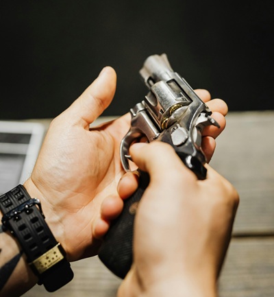 mans hands holding gun
